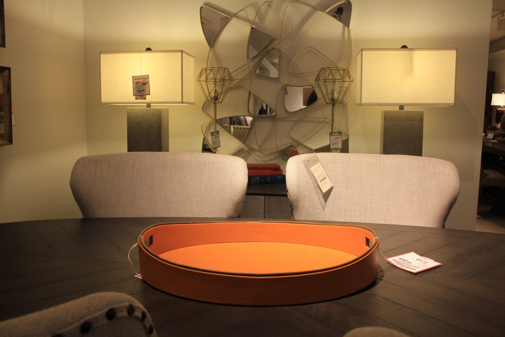Gray, modern dining room with orange accent