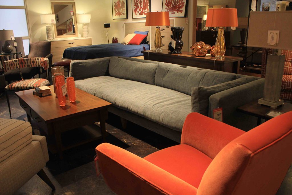 Low-slung couches, wood coffee table and an orange patterned chair