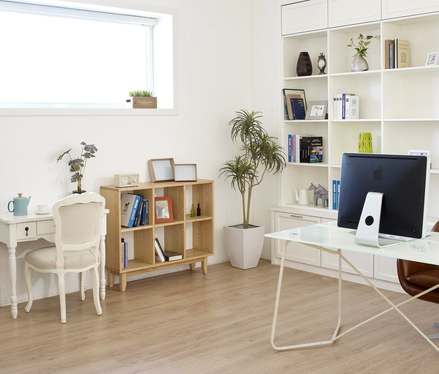 bright home office with book shelves and desk