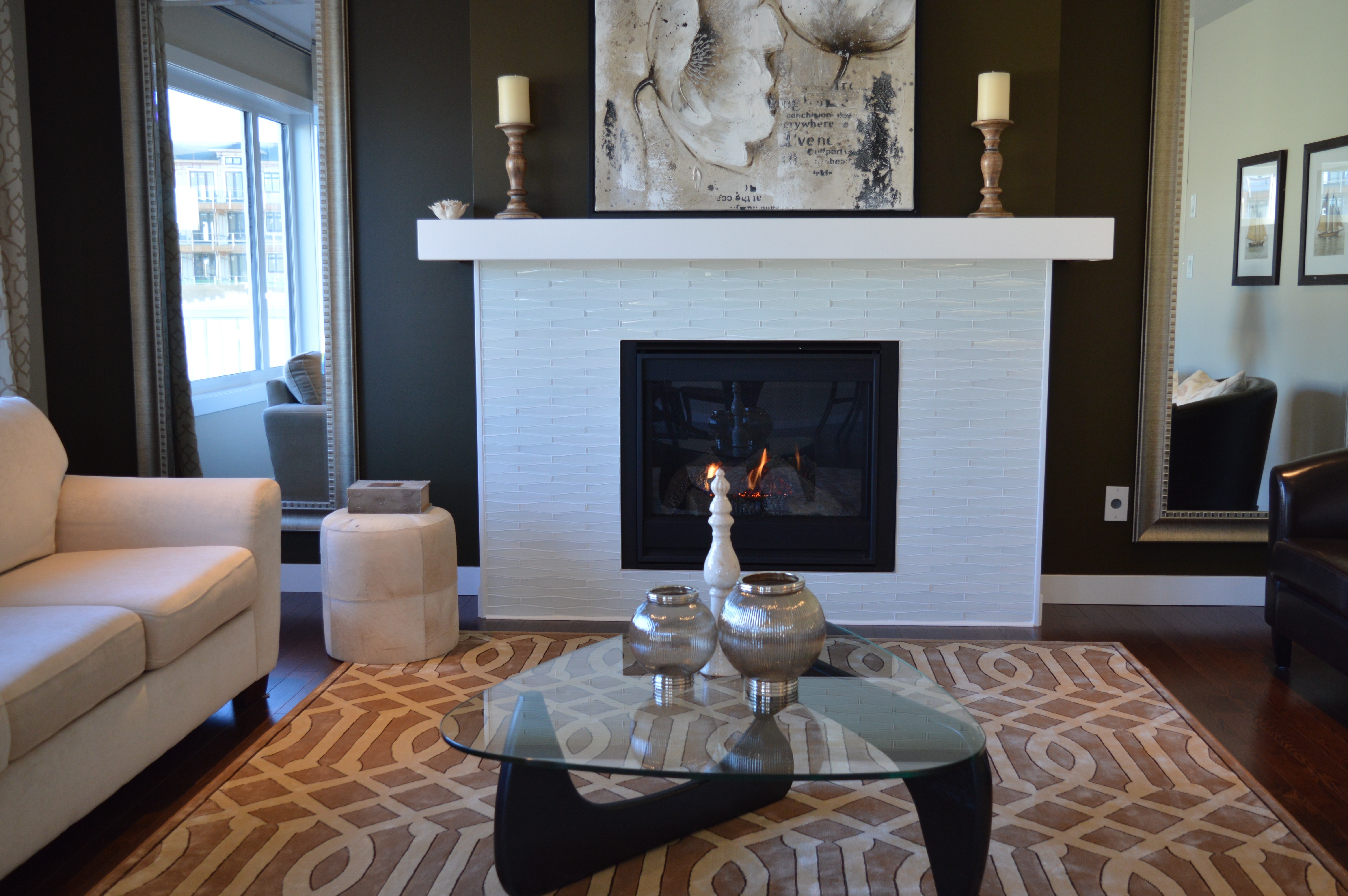 living room with white fireplace and black walls