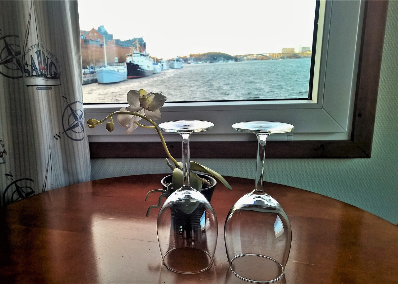 wine glasses on table overlooking the coast